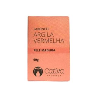 Fundo branco com sabonete ao centro, embalagem vermelha descrito sabonete argila vermelha pele madura 60g Cativa Natureza.